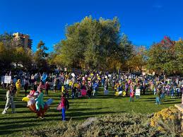 "No Kings" Events Nationwide Expected to Be Boisterous, Joyful supporters holding banners at No Kings democracy rallies across the United States